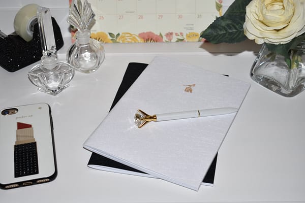 Bieffe Italian Journal Set: White journal and black journal with white diamond solitaire writing pen resting on top